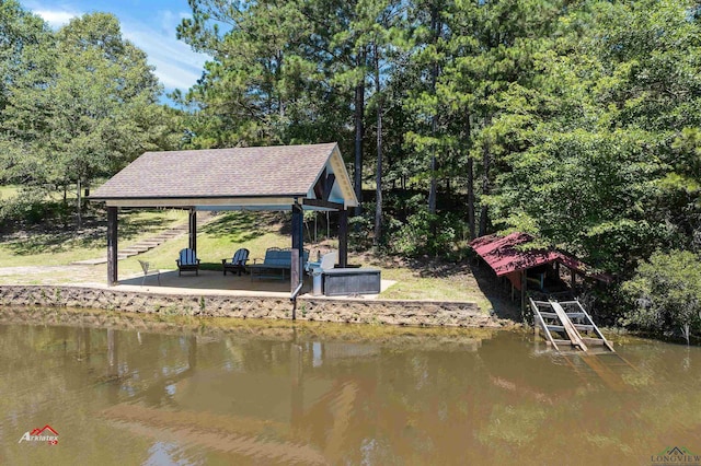 dock area with a gazebo and a water view