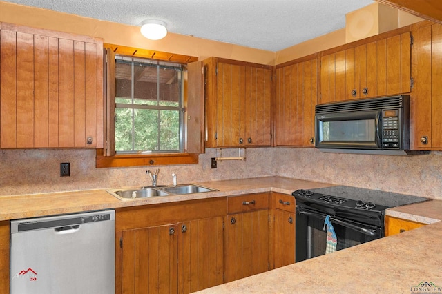 kitchen featuring black appliances, tasteful backsplash, sink, and a textured ceiling