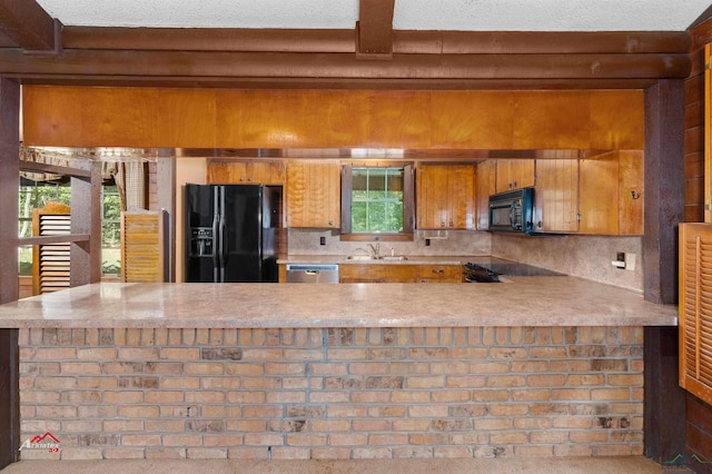 kitchen with backsplash, black appliances, sink, beamed ceiling, and kitchen peninsula