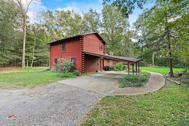 view of home's exterior featuring a yard and a carport