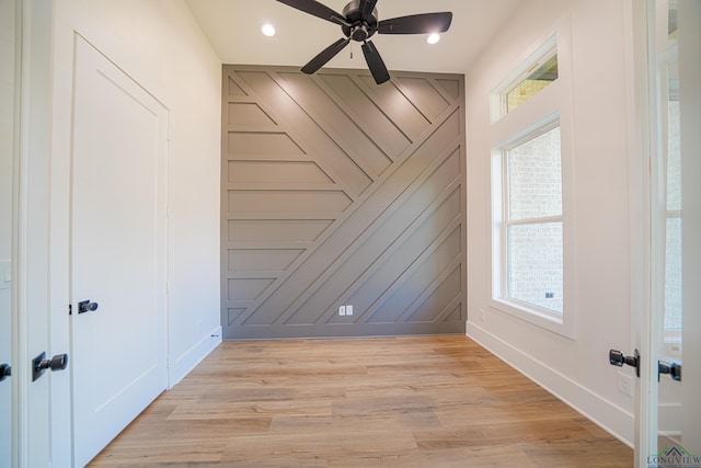 spare room with light hardwood / wood-style flooring and ceiling fan