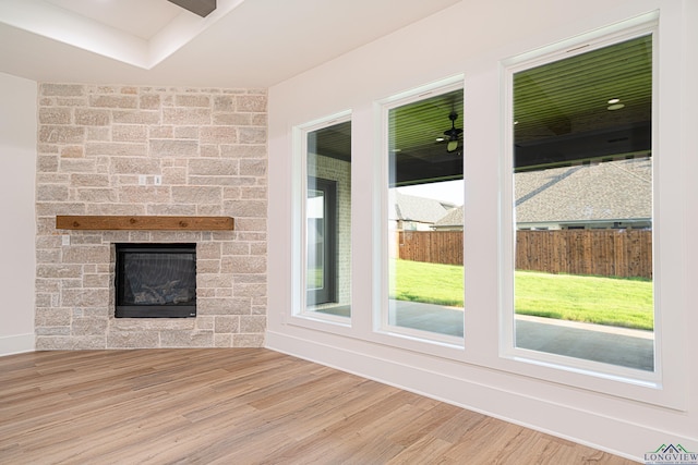 unfurnished living room featuring a fireplace and hardwood / wood-style floors