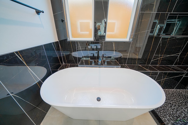 bathroom with tile patterned flooring and tile walls