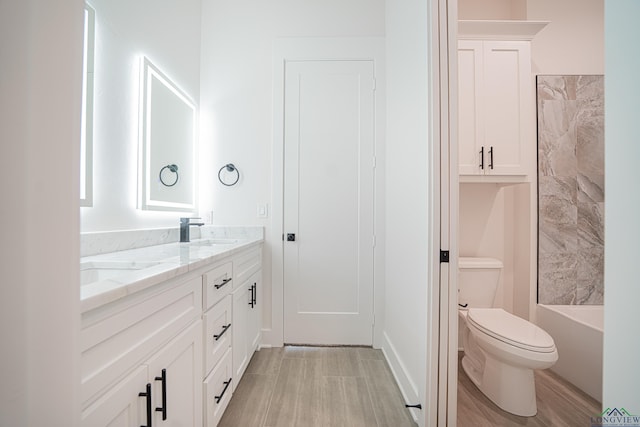 bathroom featuring vanity, toilet, and wood-type flooring