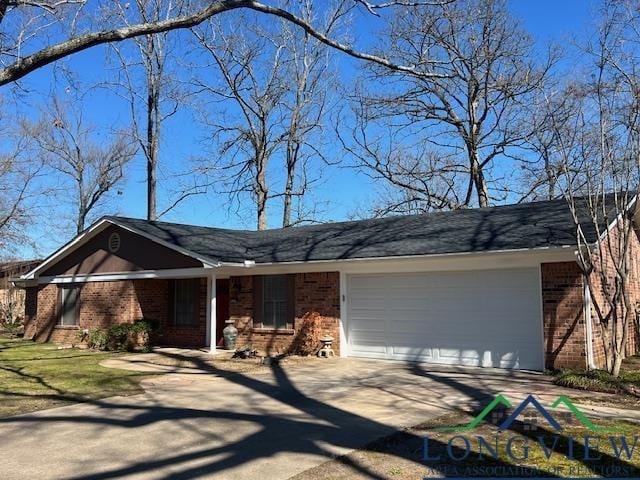 ranch-style home with a garage, driveway, and brick siding