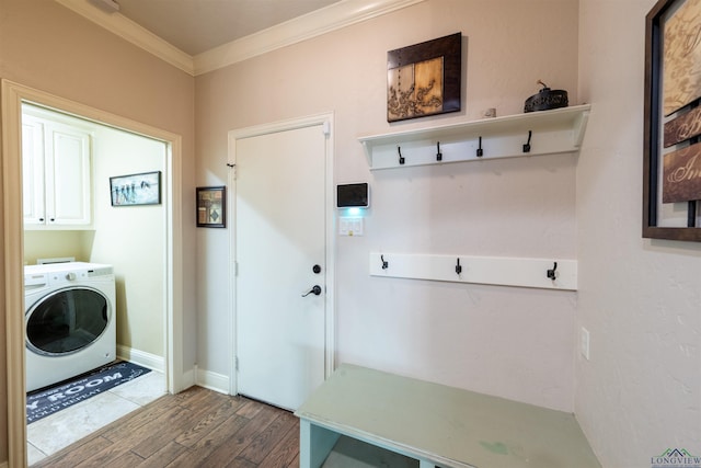 laundry room with hardwood / wood-style flooring, cabinets, crown molding, and washer / clothes dryer