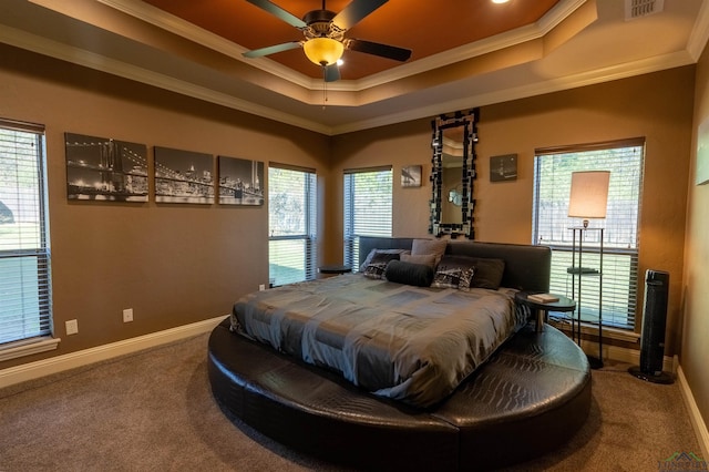 bedroom with carpet floors, a tray ceiling, ceiling fan, and ornamental molding