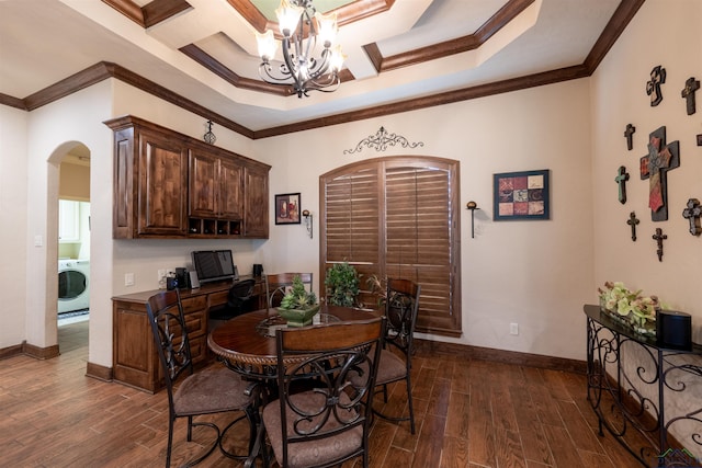 dining area featuring washer / clothes dryer, an inviting chandelier, dark hardwood / wood-style floors, and ornamental molding