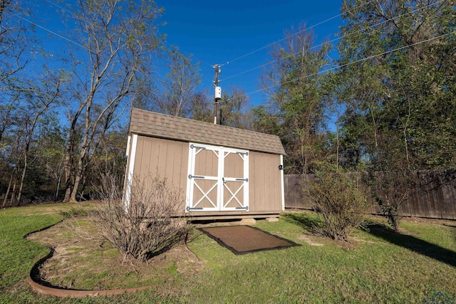 view of outdoor structure featuring a lawn