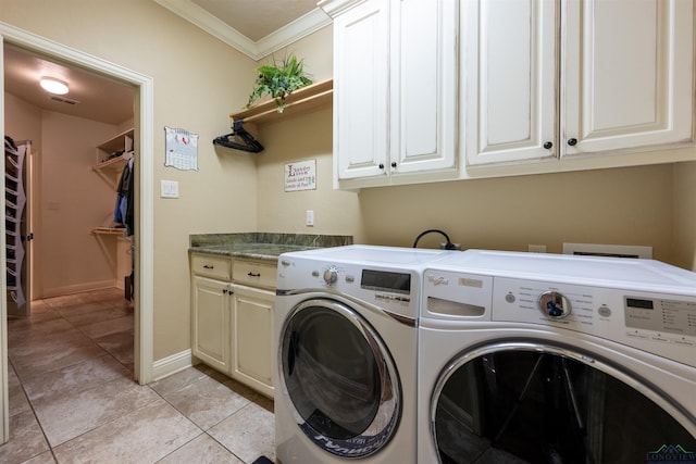 washroom featuring washer and clothes dryer, cabinets, light tile patterned floors, and crown molding