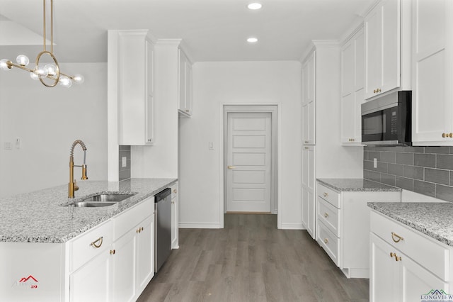 kitchen featuring white cabinets, dishwasher, pendant lighting, and sink