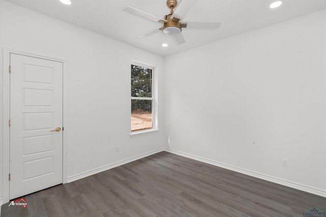 empty room featuring ceiling fan and dark wood-type flooring