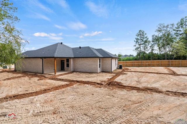 rear view of house with central air condition unit and a patio