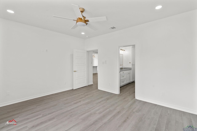 unfurnished bedroom featuring connected bathroom, ceiling fan, and light hardwood / wood-style floors