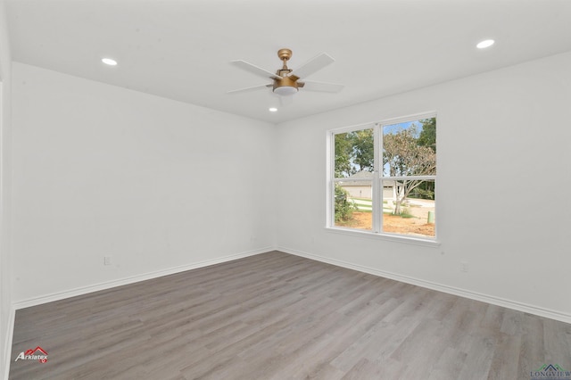 unfurnished room with ceiling fan and light wood-type flooring