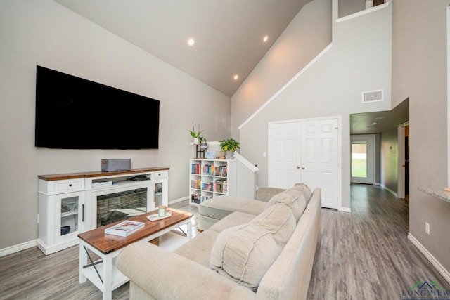 207 Reel Rd, Longview, TX 75604 - living area with high vaulted ceiling, wood finished floors, and recessed lighting