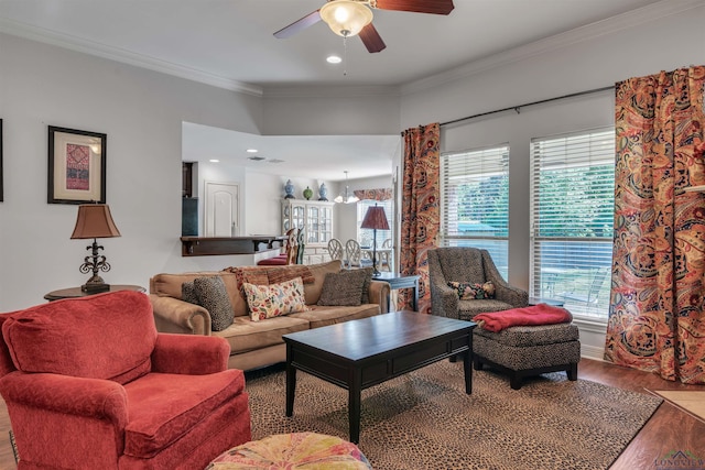 living area with a ceiling fan, wood finished floors, and a wealth of natural light