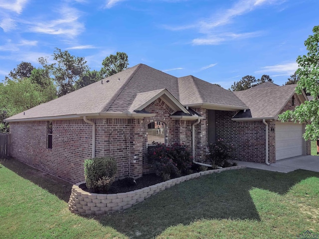 single story home with brick siding, roof with shingles, a front yard, and a garage
