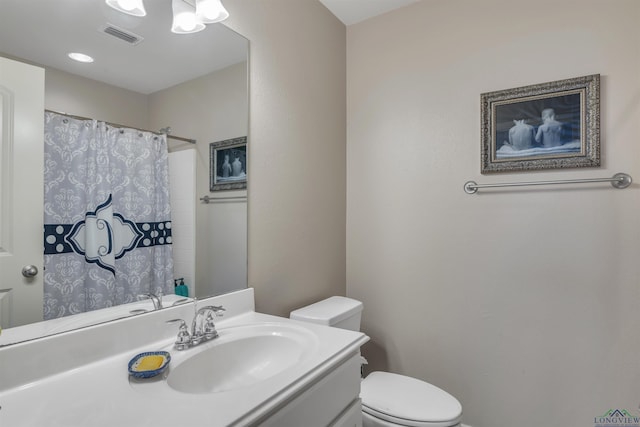 bathroom with toilet, vanity, a shower with shower curtain, and visible vents