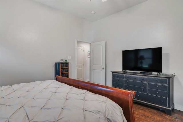 bedroom featuring wood finished floors and baseboards