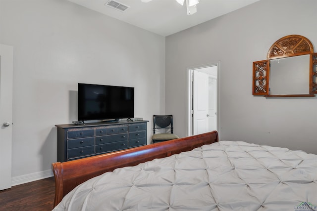 bedroom featuring baseboards, wood finished floors, and visible vents