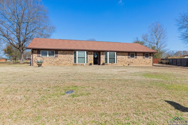 ranch-style house with brick siding, a front yard, and fence