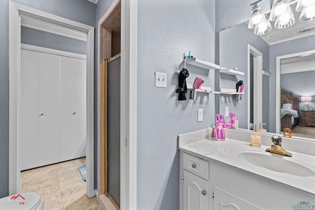 full bath featuring a textured wall, connected bathroom, a stall shower, vanity, and a chandelier