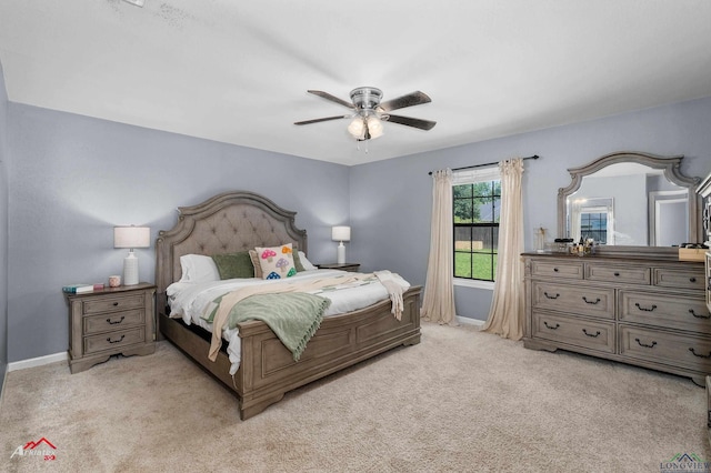 bedroom featuring light colored carpet, baseboards, and ceiling fan