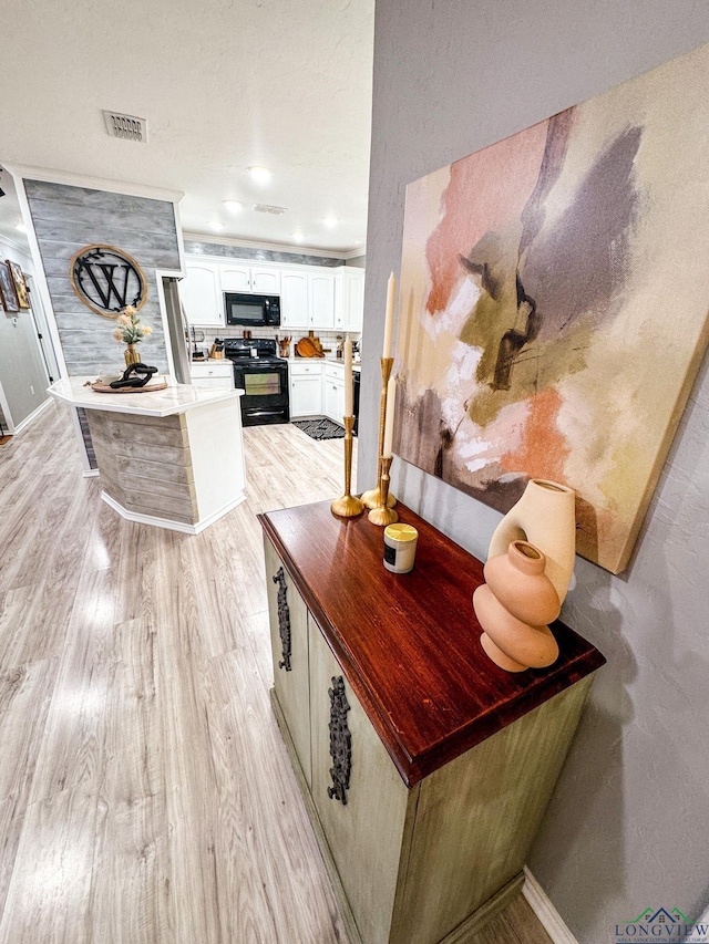 interior space featuring recessed lighting, visible vents, baseboards, and light wood-style flooring