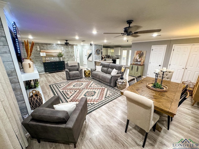 living room with recessed lighting, a fireplace, ceiling fan, ornamental molding, and light wood-type flooring