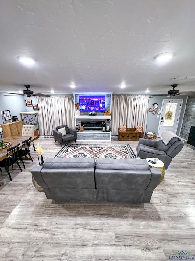 living room with wood finished floors and a ceiling fan