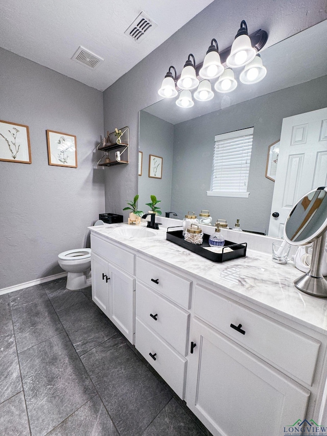 bathroom with visible vents, baseboards, toilet, and vanity