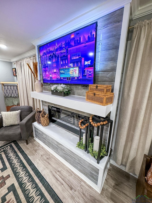 interior details featuring wood finished floors and crown molding