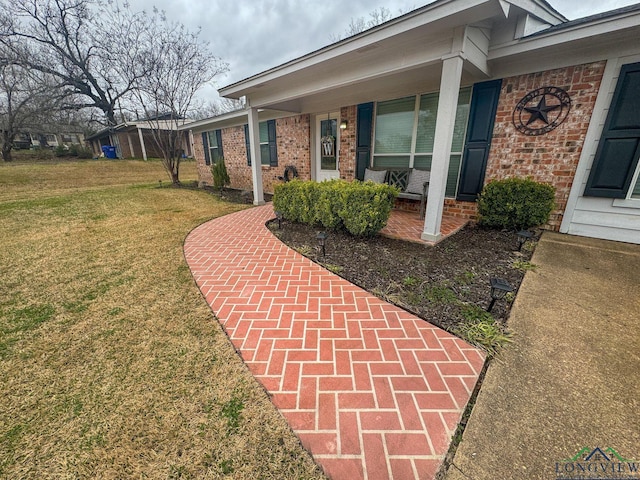 exterior space featuring a yard and brick siding