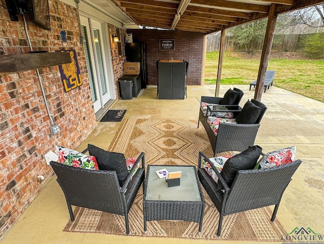 view of patio featuring outdoor lounge area and fence