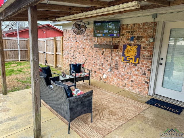 view of patio with an outdoor living space and fence