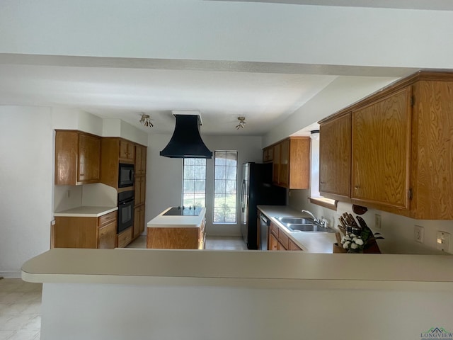 kitchen featuring black appliances, kitchen peninsula, and sink