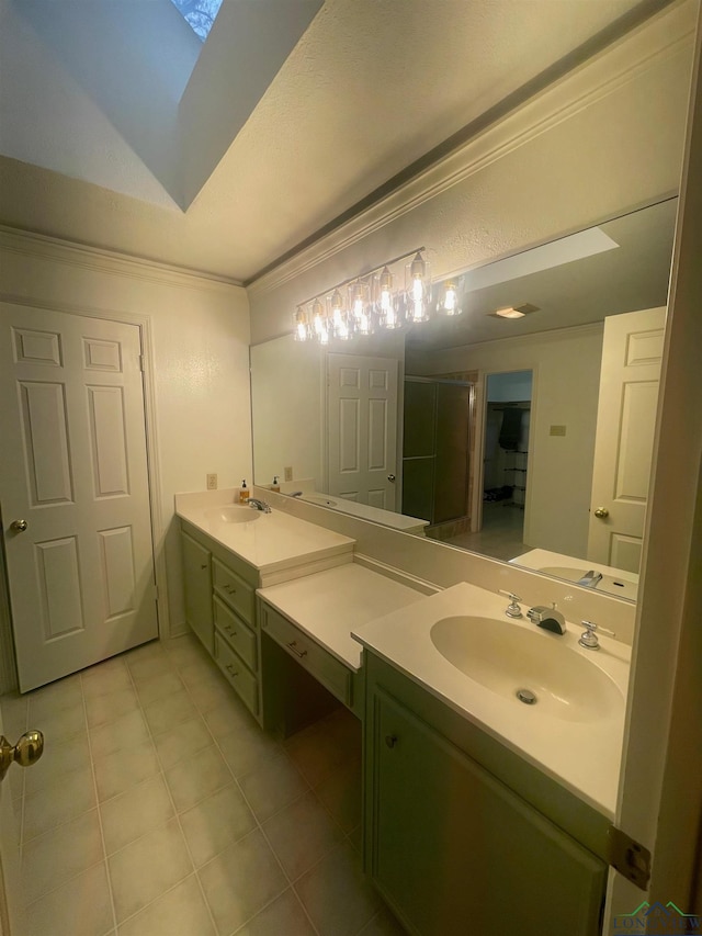 bathroom featuring a skylight, tile patterned flooring, crown molding, a shower with door, and vanity