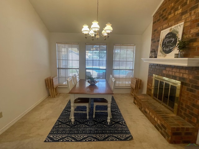 dining room featuring a fireplace, carpet, a chandelier, and lofted ceiling