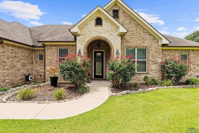 159 Jacobin Creek Dr, Gilmer, TX 75645 - french country inspired facade with brick siding, a front yard, and roof with shingles