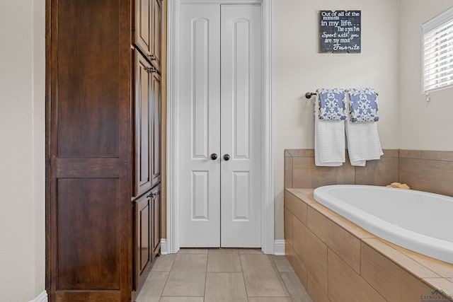 159 Jacobin Creek Dr, Gilmer, TX 75645 - bathroom featuring a closet, a bath, and tile patterned floors