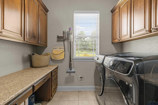 159 Jacobin Creek Dr, Gilmer, TX 75645 - laundry room with washing machine and clothes dryer, cabinet space, and light tile patterned floors