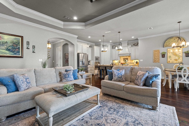 159 Jacobin Creek Dr, Gilmer, TX 75645 - living area with a chandelier, arched walkways, crown molding, dark wood-type flooring, and a raised ceiling