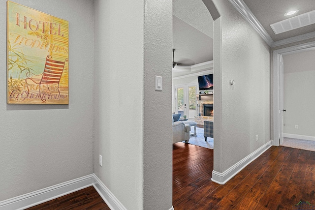 159 Jacobin Creek Dr, Gilmer, TX 75645 - hallway with hardwood / wood-style flooring, crown molding, a textured wall, arched walkways, and recessed lighting