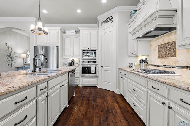 159 Jacobin Creek Dr, Gilmer, TX 75645 - kitchen with appliances with stainless steel finishes, crown molding, white cabinets, recessed lighting, and arched walkways