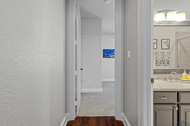 159 Jacobin Creek Dr, Gilmer, TX 75645 - hallway with a textured wall and dark wood finished floors