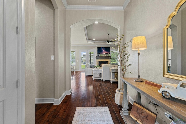 159 Jacobin Creek Dr, Gilmer, TX 75645 - hall featuring crown molding, wood-type flooring, a textured wall, a raised ceiling, and arched walkways