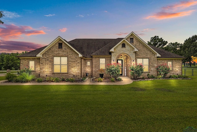 159 Jacobin Creek Dr, Gilmer, TX 75645 - view of front of home featuring brick siding, a front yard, and a shingled roof