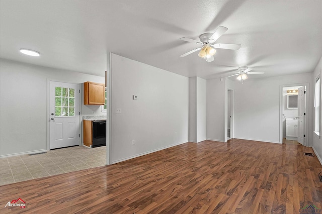 209 Norton Dr, Longview, TX 75602 - unfurnished living room with light wood finished floors, a ceiling fan, and baseboards