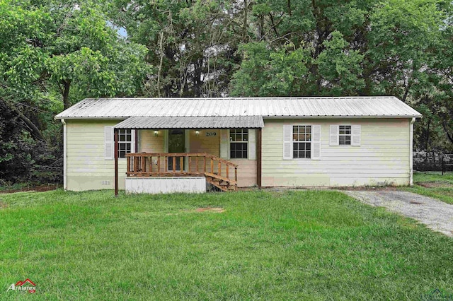 209 Norton Dr, Longview, TX 75602 - ranch-style home featuring a porch, a front yard, and metal roof